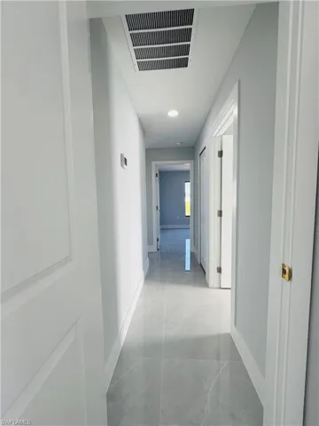Hallway featuring baseboards and recessed lighting