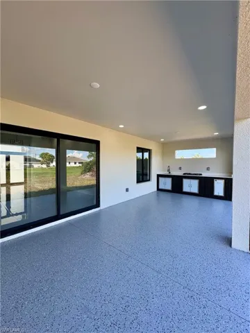 Unfurnished living room with recessed lighting and speckled floor