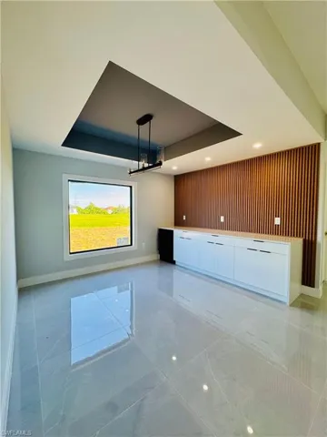 Spare room featuring a tray ceiling and recessed lighting