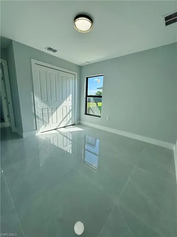 Spare room featuring baseboards