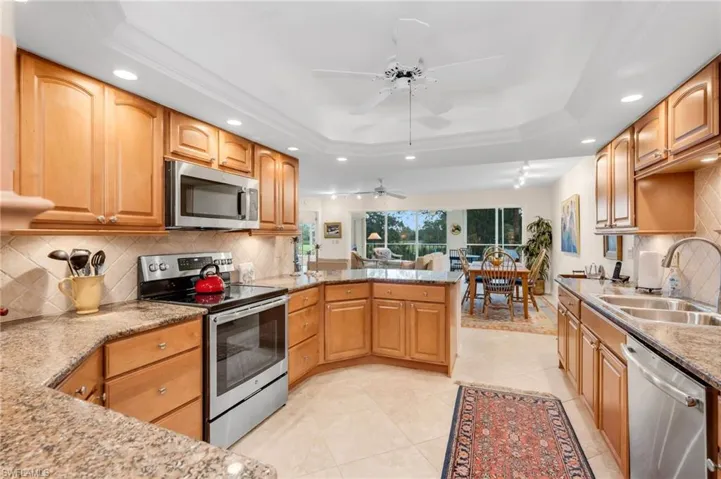 Kitchen with wood cabinets, granite counters, and stainless appliances.