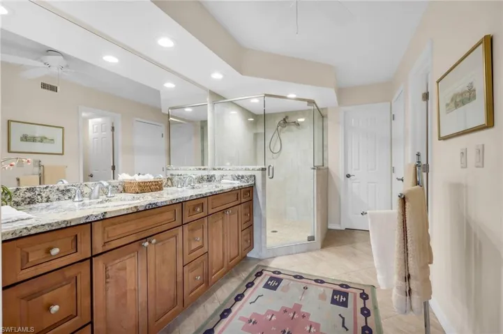 Spacious en suite bathroom with double sinks and walk in shower.