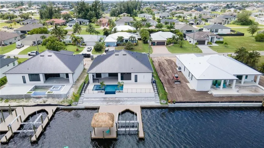 Birds eye view of property with a water view