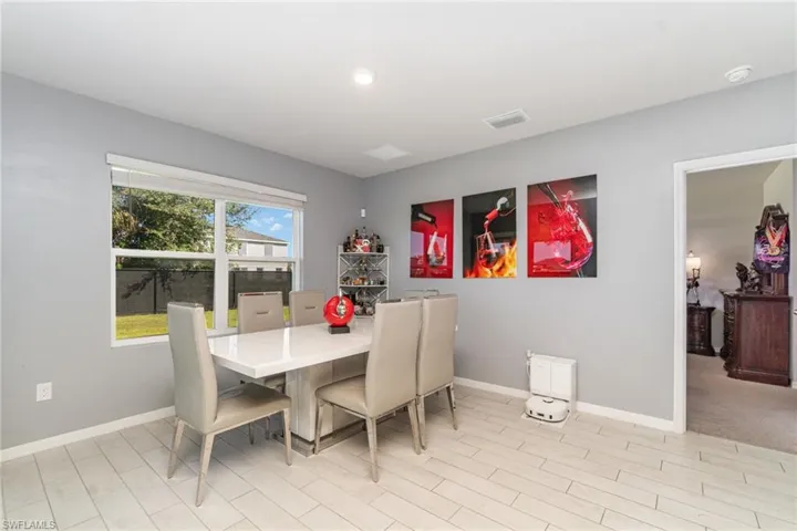 Dining area with baseboards and wood finish floors