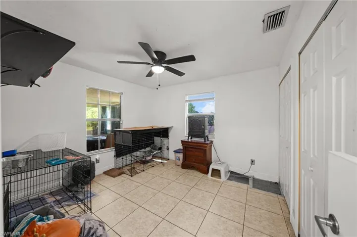 Office space with light tile patterned floors and ceiling fan