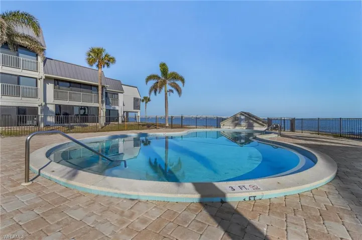 View of pool with a patio and a water view