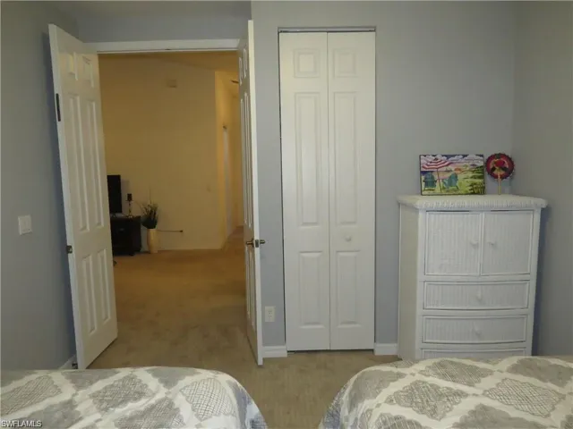 Bedroom featuring a closet and light colored carpet