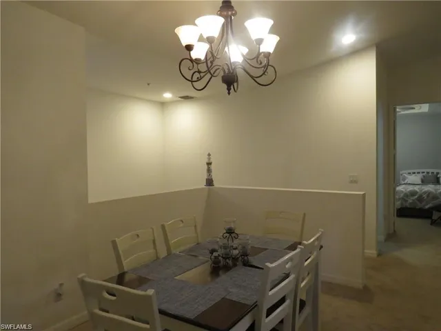 Dining room featuring a chandelier and carpet