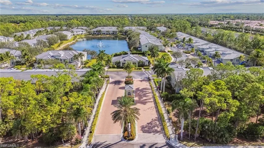 Aerial view of residential area featuring a nearby body of water