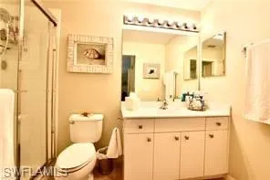 Full bath featuring vanity and a shower stall