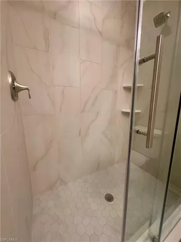 Full bathroom featuring a stall shower