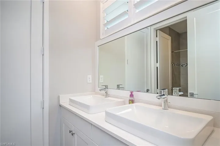 Full bath featuring double vanity