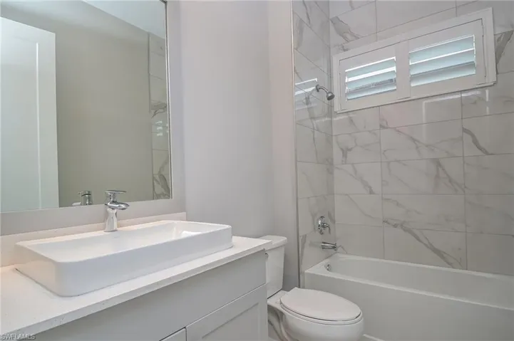 Bathroom featuring vanity and shower / bathtub combination