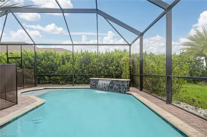 Swimming pool featuring a screened-in lanai.