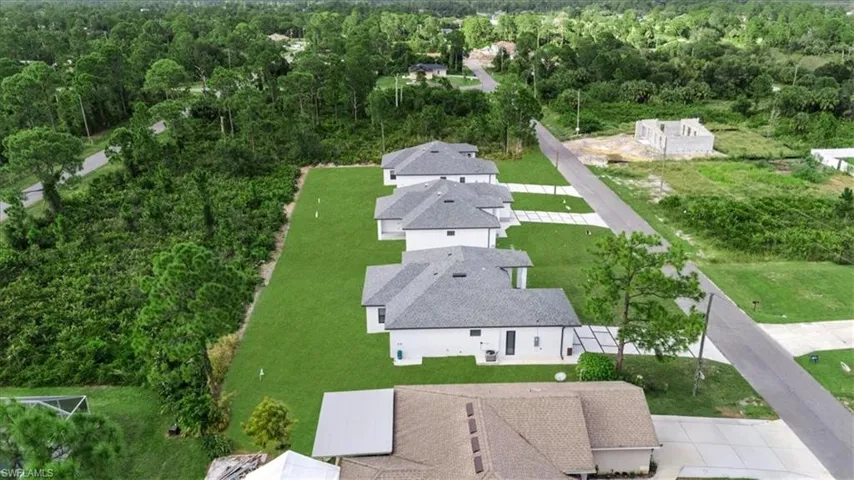 Aerial perspective of suburban area with a forest