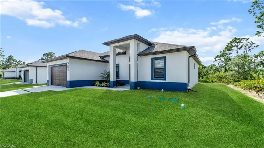 View of front facade with a front lawn, a garage, concrete driveway, and roof with shingles