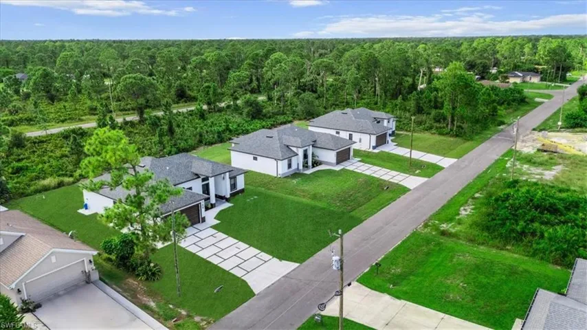 Aerial view of residential area with a heavily wooded area