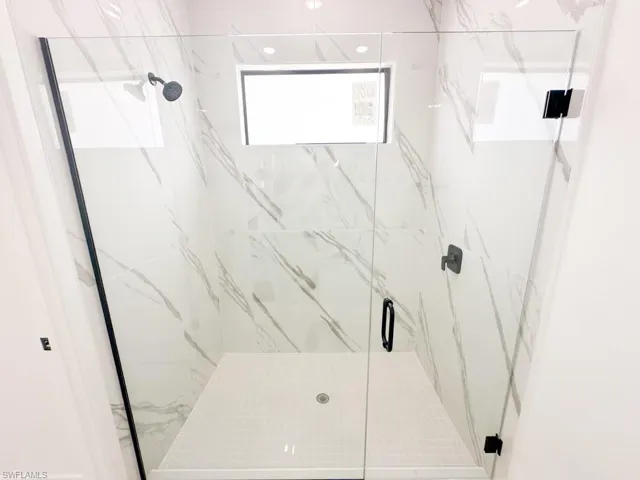 Bathroom with a shower with door