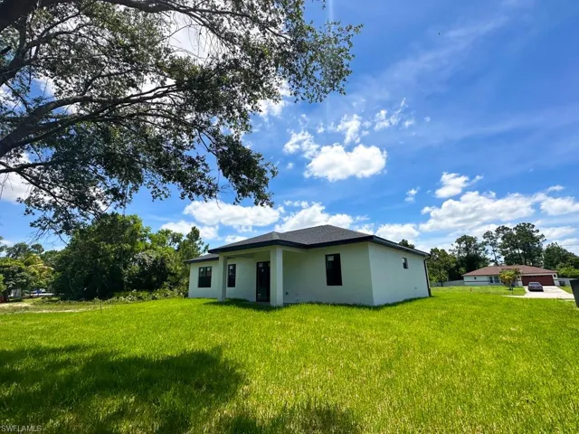 View of home's exterior with a yard