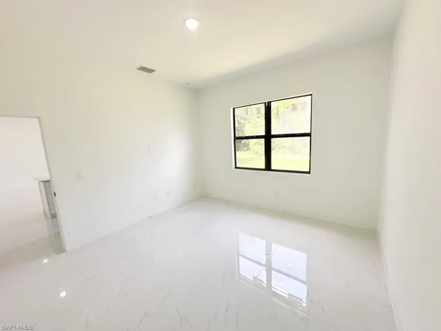 Empty room with light tile floors