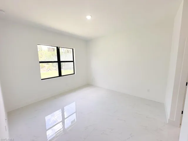 Unfurnished room with light tile floors