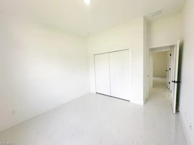 Unfurnished bedroom with tile flooring and a closet
