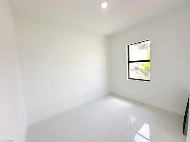 Empty room featuring tile floors