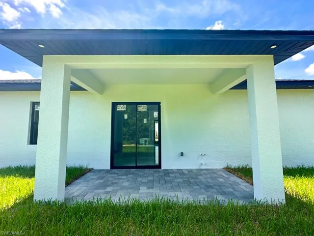 Property entrance with a patio area