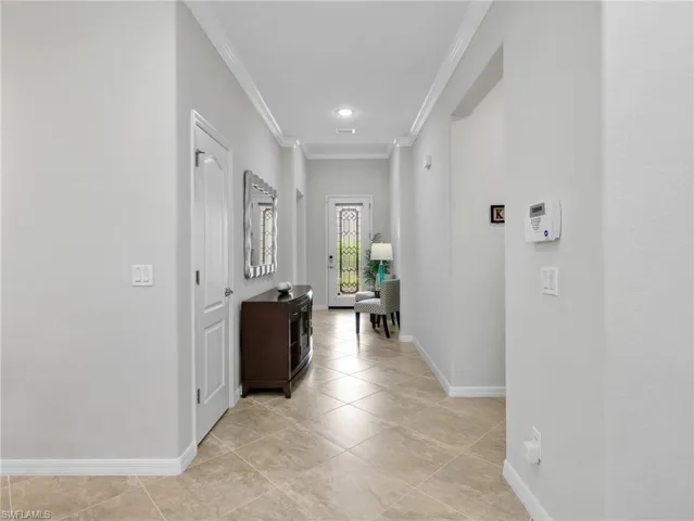 Dining Room with Track Lighting & Crown Molding Leading To Front Entry Foyer
