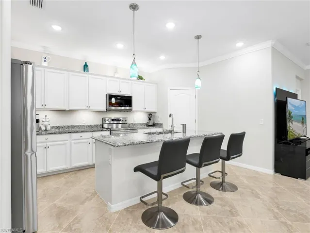 Kitchen with Sparkling New LG Stainless Steel Appliances, White Shaker Cabinetry, Under & Above Counter Lighting, Granite Counters, Pendant Lighting, & Crown Molding