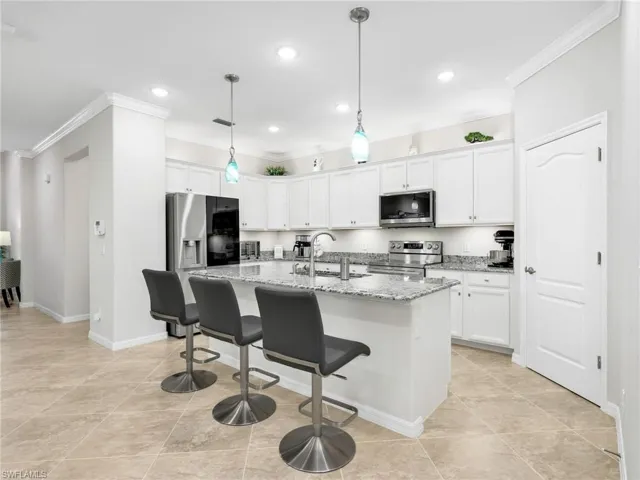Kitchen with Island, White Shaker Cabinetry, Sparkling New Stainless Steel LG Appliances, Under & Above Counter Lighting, Pendant Lighting, Crown Molding, & Walk-In Pantry