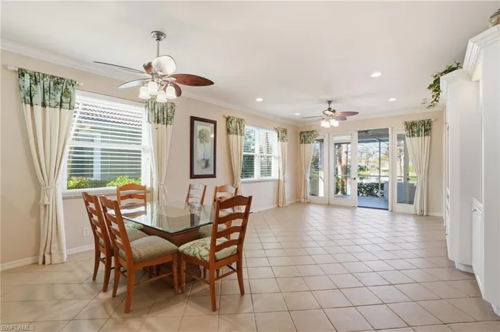 Dining area with ornamental molding, ceiling fan, recessed lighting, and light tile patterned floors - Virtually Edited Image