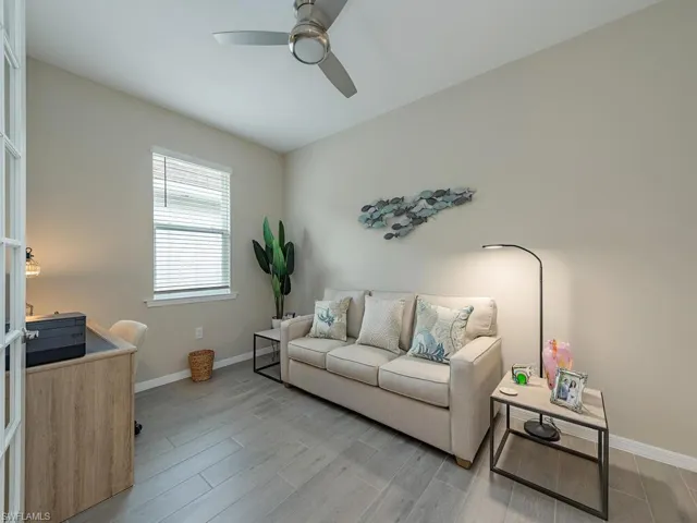 Living room featuring light hardwood / wood-style floors and ceiling fan