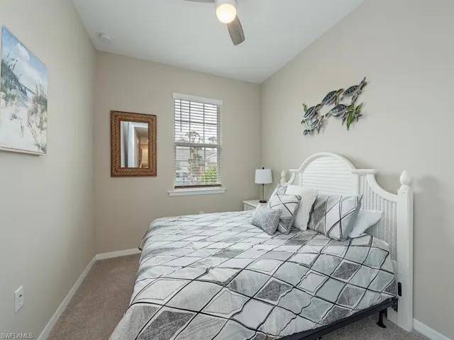 Bedroom with light carpet and ceiling fan