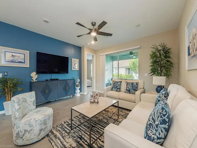 Living room featuring ceiling fan and hardwood / wood-style floors