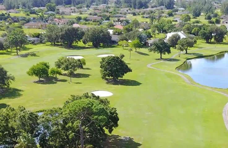 Surrounding community with view of golf course, a residential view, and a water view