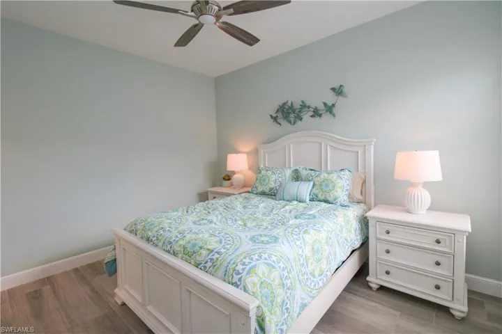 Bedroom with ceiling fan and light hardwood / wood-style floors