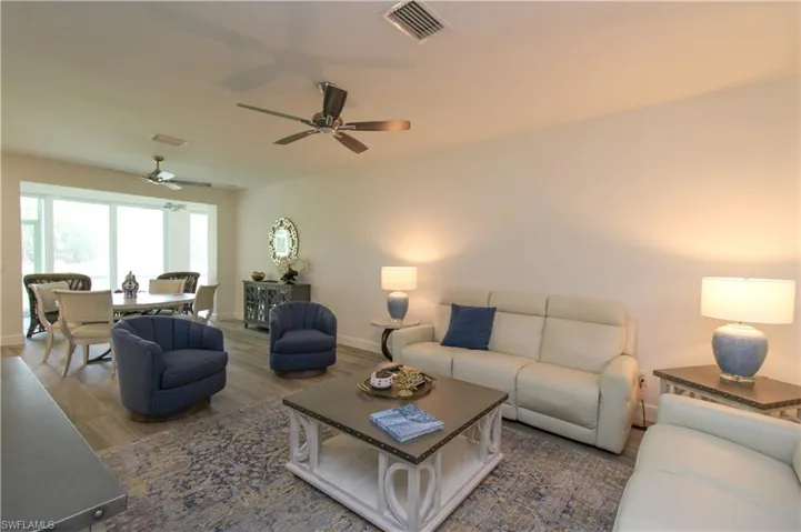Living room featuring wood-type flooring and ceiling fan