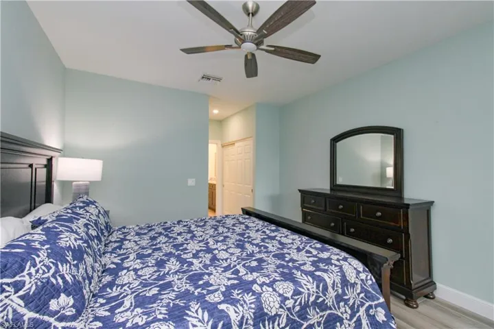Bedroom featuring a closet, wood-type flooring, and ceiling fan