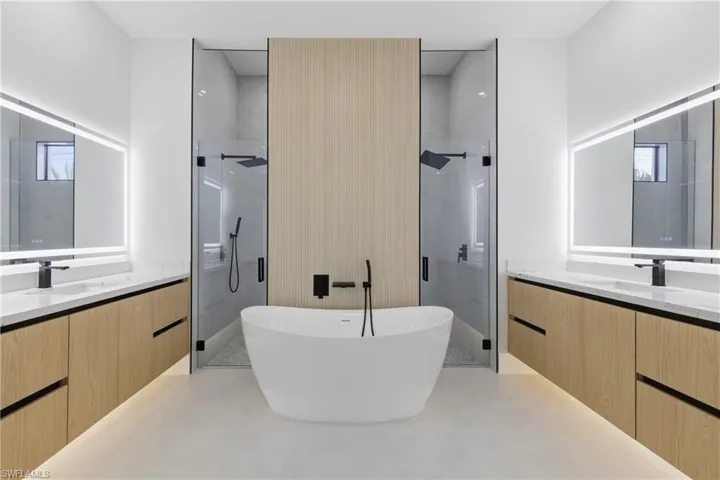 Bathroom with vanity, a shower stall, and a soaking tub