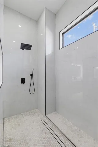 Bathroom with a marble finish shower