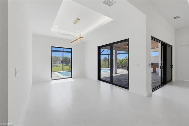 Spare room with a raised ceiling and recessed lighting