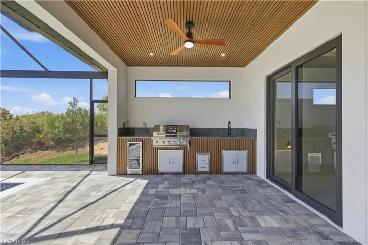 Outdoor pool featuring a sunroom, a water view, and a lanai