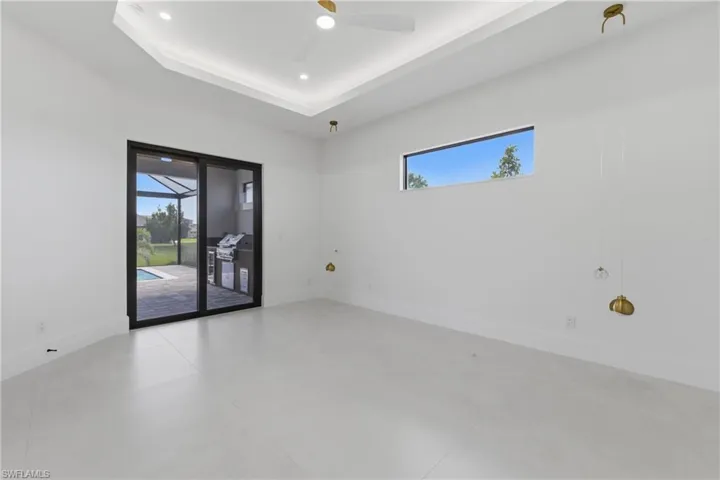 Spare room featuring ceiling fan, a raised ceiling, and recessed lighting