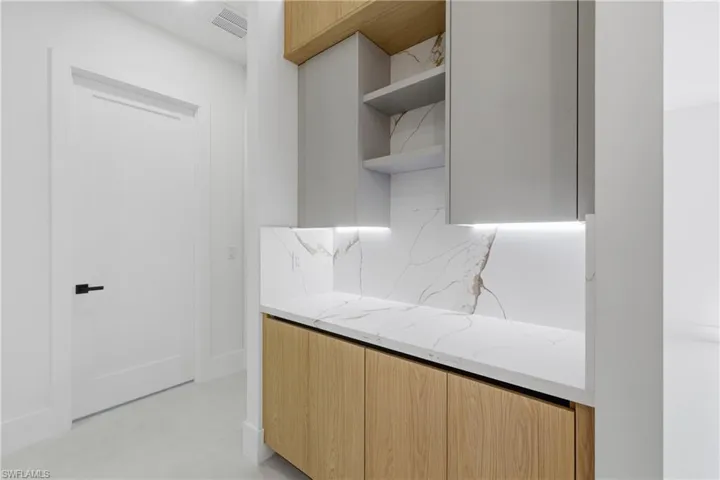 Laundry room featuring hookup for a washing machine, electric dryer hookup, and cabinet space