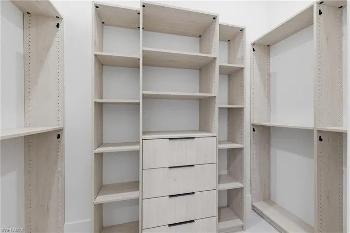 Bathroom with a shower stall, two vanities, and a freestanding bath