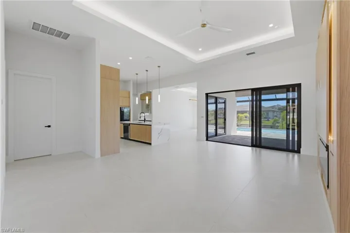 Unfurnished living room featuring a ceiling fan and recessed lighting