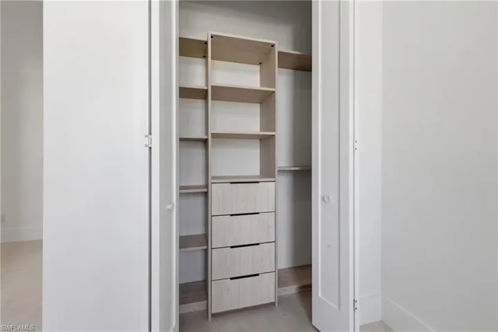 Swimming pool featuring exterior kitchen, a sunroom, a patio, a lanai, and a residential view