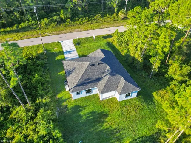 View from above of property featuring a tree filled landscape