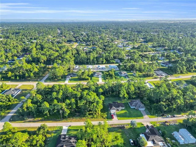 Aerial view of property's location with nearby suburban area